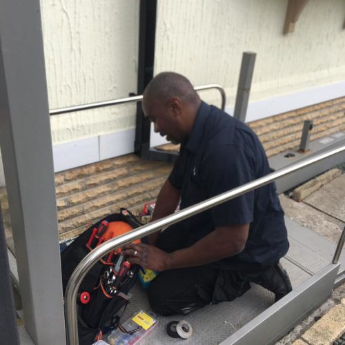 AMS workman maintaining outdoor stairlift