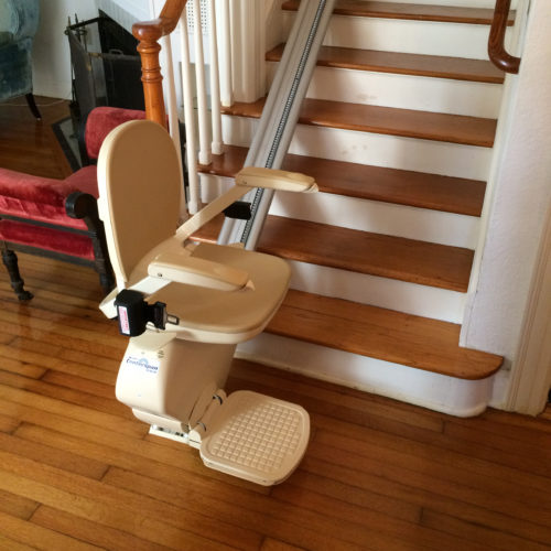 Stationary stairlift at the bottom of staircase