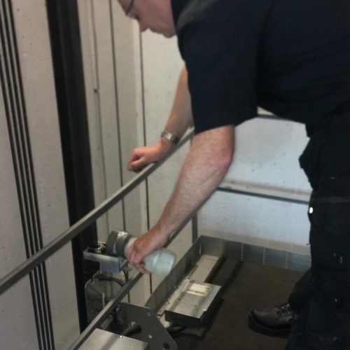 AMS workman inspecting lift