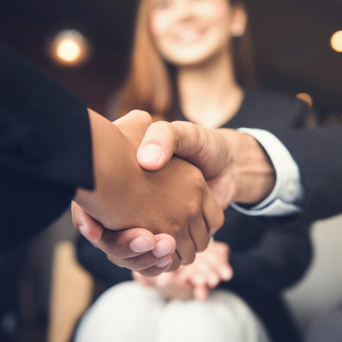 Businessmen making handshake with his partner in cafe - business etiquette, congratulation, merger and acquisition concepts